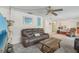 Inviting living room with comfortable seating, a ceiling fan, and stylish decor at 2717 Warwick Ter, Palm Harbor, FL 34685