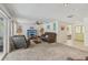Bright living room showcasing a brown sofa, tile flooring, and a view to other rooms at 2717 Warwick Ter, Palm Harbor, FL 34685