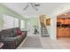 Bright living room with tile flooring, a comfortable sofa, and stairway at 2717 Warwick Ter, Palm Harbor, FL 34685