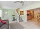 Open living room with tile flooring, a grey sofa, and a glimpse into the kitchen and dining area at 2717 Warwick Ter, Palm Harbor, FL 34685