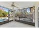 Enclosed patio with a ceiling fan, BBQ, and views of the pool and backyard at 2717 Warwick Ter, Palm Harbor, FL 34685