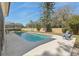 A relaxing pool surrounded by a concrete deck and lush green grass, perfect for outdoor enjoyment at 2717 Warwick Ter, Palm Harbor, FL 34685