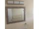 Bathroom mirror with decorative frame and modern lighting at 3641 Dickens Dr, Holiday, FL 34691