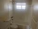 Bathroom with a tub and shower combo with white tile surround at 3641 Dickens Dr, Holiday, FL 34691