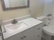 Bright bathroom featuring a modern vanity with white countertop and updated fixtures at 3641 Dickens Dr, Holiday, FL 34691