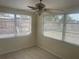 Bright bedroom with a ceiling fan and three windows providing natural light at 3641 Dickens Dr, Holiday, FL 34691