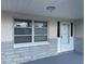 Close-up of the front porch, showcasing a secure front door and large window at 3641 Dickens Dr, Holiday, FL 34691