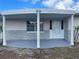 A view of the covered front porch that provides ample shade and curb appeal at 3641 Dickens Dr, Holiday, FL 34691