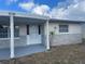 A wider angle of the front porch and door of a home at 3641 Dickens Dr, Holiday, FL 34691