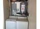 Functional laundry area features a washer, dryer, and a water heater for added convenience at 3641 Dickens Dr, Holiday, FL 34691