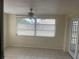 Tile-floored living room with window and access to outside, providing lots of light at 3641 Dickens Dr, Holiday, FL 34691
