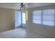 Bright living room featuring tile flooring, ceiling fan, and large window at 3641 Dickens Dr, Holiday, FL 34691