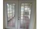 Enclosed patio, visible through a pair of french doors at 3641 Dickens Dr, Holiday, FL 34691