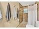 A tiled shower is showcased in a bright bathroom with a shower curtain and a showerhead at 3944 Sprucewood Pl, Land O Lakes, FL 34639
