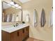 Modern bathroom with a wood vanity, stylish lighting, and neutral-colored walls, creating a serene atmosphere at 3944 Sprucewood Pl, Land O Lakes, FL 34639