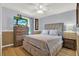 Comfortable bedroom featuring a bed, a ceiling fan, and two-tone walls at 3944 Sprucewood Pl, Land O Lakes, FL 34639