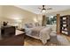 Comfortable bedroom with a ceiling fan, a window with views, and a storage shelf filled with linens at 3944 Sprucewood Pl, Land O Lakes, FL 34639