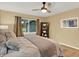 Cozy bedroom with a ceiling fan, natural light, and stylish decor, offering a relaxing retreat at 3944 Sprucewood Pl, Land O Lakes, FL 34639