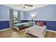 Bright bedroom featuring a bed, a ceiling fan, and two-tone walls at 3944 Sprucewood Pl, Land O Lakes, FL 34639