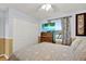 Well lit bedroom featuring a bed, a ceiling fan, and a view of the lake at 3944 Sprucewood Pl, Land O Lakes, FL 34639
