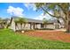 Charming single-story home with manicured lawn and colorful landscaping at 3944 Sprucewood Pl, Land O Lakes, FL 34639