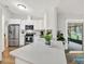 Bright kitchen featuring stainless steel appliances, quartz countertops, and seamless access to the backyard at 3944 Sprucewood Pl, Land O Lakes, FL 34639