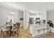 Open-concept kitchen with white cabinets, stainless steel appliances, and bar seating, blending seamlessly with the dining area at 3944 Sprucewood Pl, Land O Lakes, FL 34639