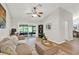 Bright living room featuring vaulted ceiling, neutral palette, modern decor, and view of screened porch at 3944 Sprucewood Pl, Land O Lakes, FL 34639