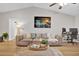 Bright living room featuring vaulted ceiling, neutral palette, modern decor, and wood-look flooring at 3944 Sprucewood Pl, Land O Lakes, FL 34639