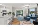 Bright living area featuring an accent wall and large windows, blending seamlessly with the kitchen area at 3944 Sprucewood Pl, Land O Lakes, FL 34639