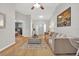 Bright living room featuring vaulted ceiling, neutral palette, modern decor, and wood-look flooring at 3944 Sprucewood Pl, Land O Lakes, FL 34639