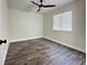Cozy bedroom with wood-look flooring, a ceiling fan, and natural light at 4036 Cortez Dr # A, Tampa, FL 33614