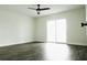 Bedroom with wood-look floors, ceiling fan, and natural light from sliding glass doors at 4036 Cortez Dr # A, Tampa, FL 33614