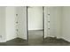 Bedroom with folding closet doors and gray wood-look laminate flooring at 4036 Cortez Dr # A, Tampa, FL 33614