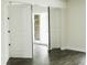 Hallway featuring wood-look flooring, access to storage space, and bright white trim at 4036 Cortez Dr # A, Tampa, FL 33614