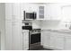 Modern kitchen featuring white cabinetry, subway tile backsplash, stainless steel appliances, and stone countertops at 4036 Cortez Dr # A, Tampa, FL 33614