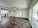 Spacious living area featuring sliding glass doors, barn doors, and wood-look floors overlooking the open-concept kitchen at 4036 Cortez Dr # A, Tampa, FL 33614