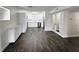 Open-concept living and kitchen area with wood floors and a bright, white kitchen and french doors at 4036 Cortez Dr # A, Tampa, FL 33614