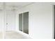 White enclosed patio with a ceiling fan and sliding glass door at 4036 Cortez Dr # A, Tampa, FL 33614
