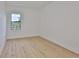 Bright bedroom featuring wood floors, white walls, and a window, offering a clean and modern space at 418 W Frances Ave # 1, Tampa, FL 33602