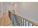 Staircase and hallway with hardwood floors, wooden railings, and white walls at 418 W Frances Ave # 1, Tampa, FL 33602