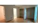 Bright bedroom features a closet and a bathroom through doorway with hardwood floors and neutral walls at 418 W Frances Ave # 2, Tampa, FL 33602