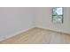 Bright bedroom featuring light hardwood floors, a large window and white walls at 418 W Frances Ave # 2, Tampa, FL 33602