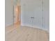 Bright bedroom featuring light wood floors and a closet with double doors at 418 W Frances Ave # 2, Tampa, FL 33602