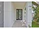 Close up of the modern glass front door to the property with a tiled front walkway at 418 W Frances Ave # 2, Tampa, FL 33602