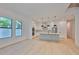 Bright open-concept kitchen and living area featuring hardwood floors and modern appliances at 418 W Frances Ave # 2, Tampa, FL 33602