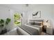 Bright bedroom featuring a large window and a comfortable bed with stylish gray accents at 4320 51St S Ave, St Petersburg, FL 33711
