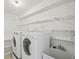 Functional laundry room with modern washer and dryer, sink, and storage shelves at 4320 51St S Ave, St Petersburg, FL 33711