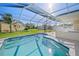 Inviting in-ground pool with screened enclosure and lush landscaping, creating a serene backyard oasis at 4320 51St S Ave, St Petersburg, FL 33711