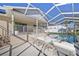 Relaxing screened-in pool area with sun loungers, perfect for enjoying sunny days by the water at 4320 51St S Ave, St Petersburg, FL 33711